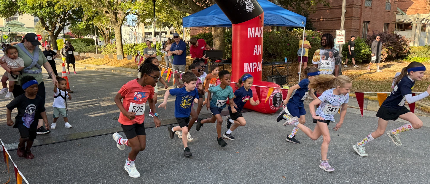 group of young runners leaving the starting line at Red Shoes Run