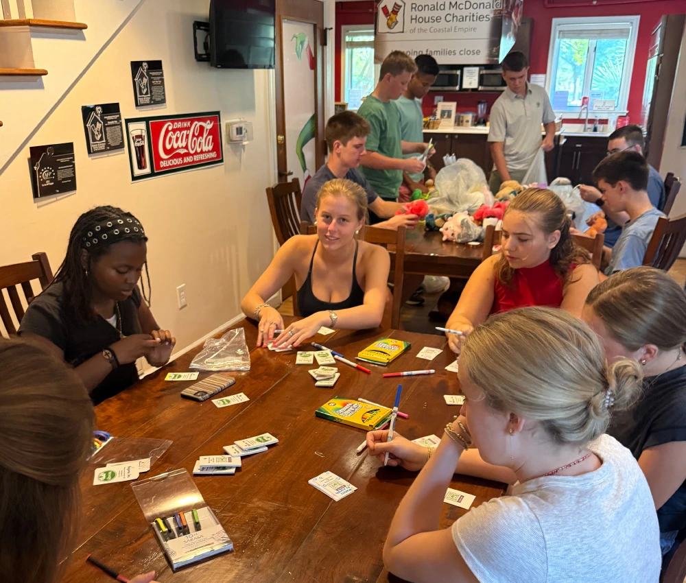 group of teenage volunteers gathered for games with our families
